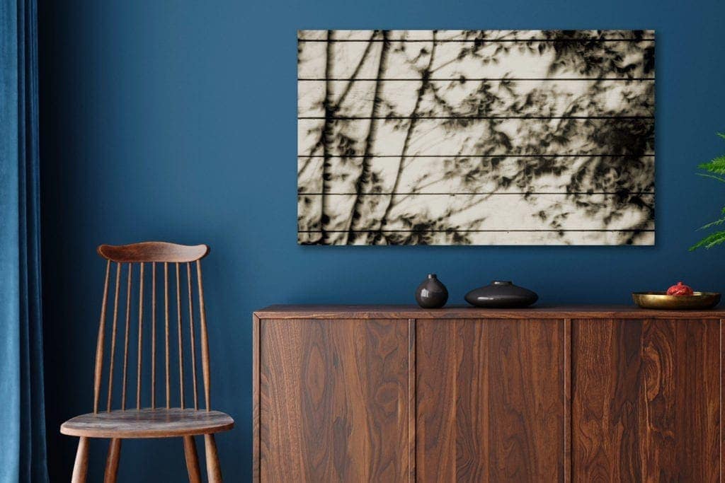 photo: Eclipse Over Mojave II shown in example room with dark blue walls.