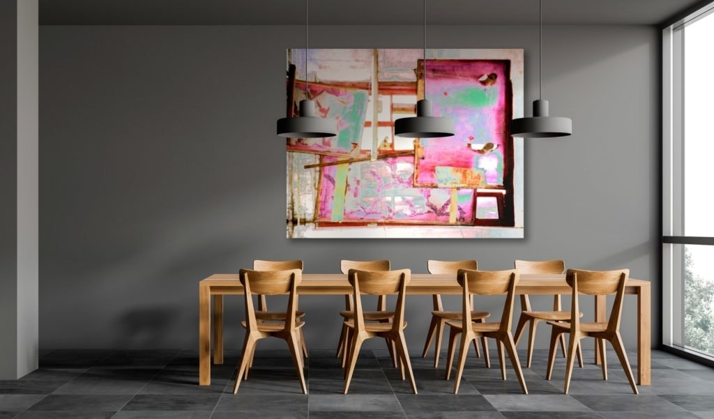 photo: large, colorful print of Silk Road Station against the cool grays of a contemporary dining room and kitchen.